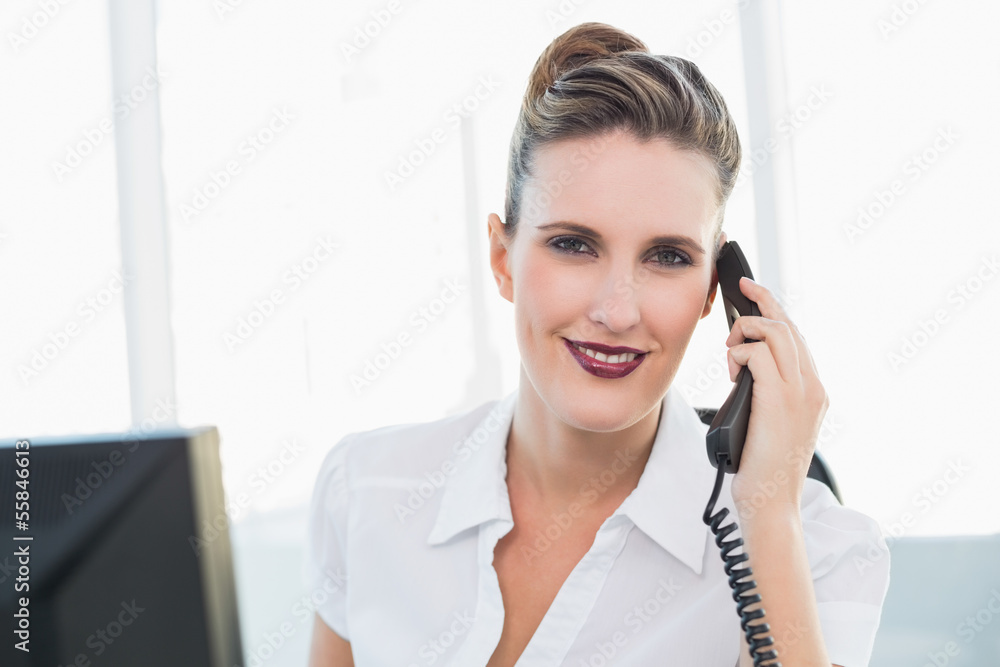 Smiling classy businesswoman talking on the phone Smiling classy businesswoman talking on the phone