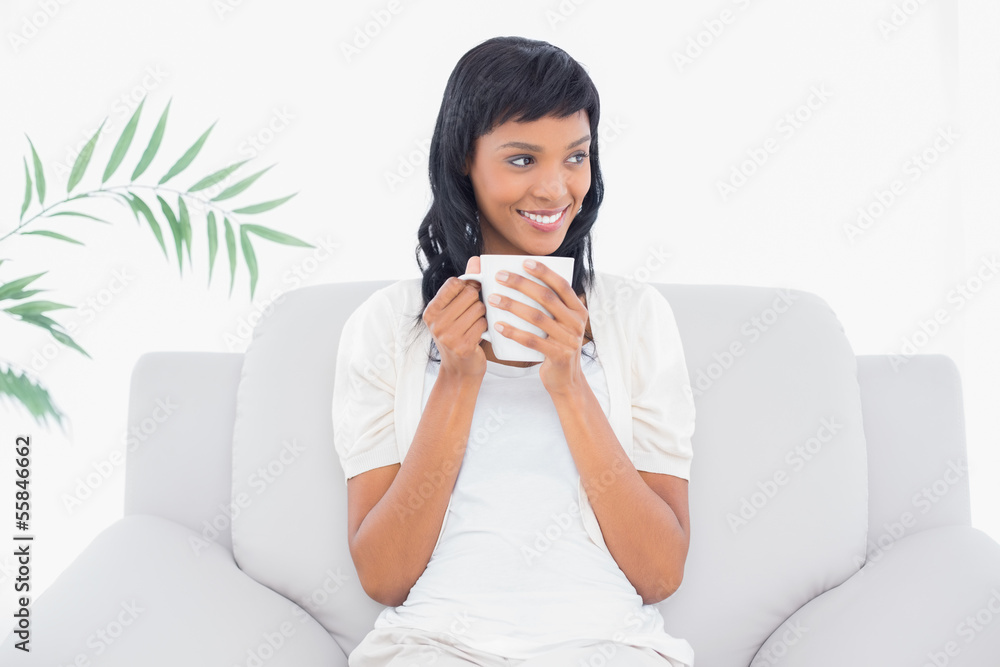 Pensive black haired woman in white clothes enjoying coffee Pensive black haired woman in white clothes enjoying coffee