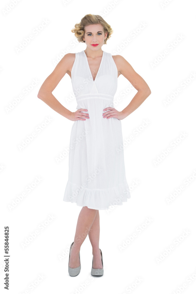 Lovely fashion blonde model posing with hands on the hips Lovely fashion blonde model posing with hands on the hips