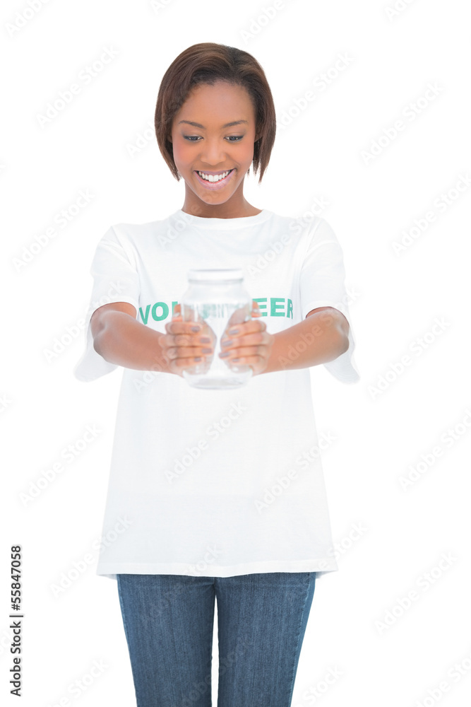 Cheerful volunteer woman holding glass jar Cheerful volunteer woman holding glass jar