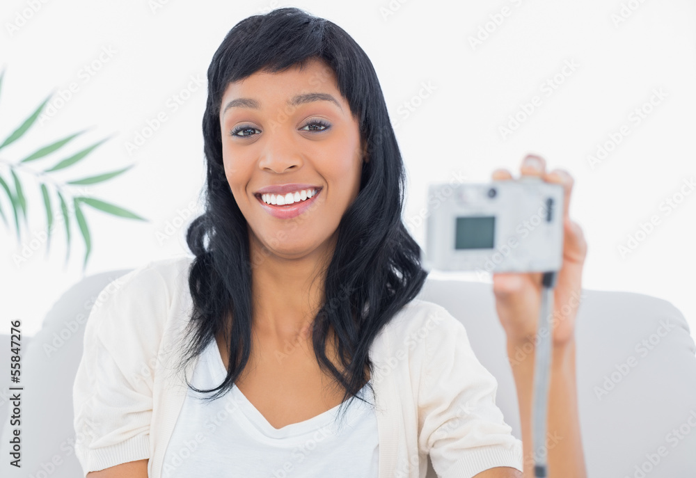 Laughing black haired woman in white clothes taking a picture of Laughing black haired woman in white clothes taking a picture of