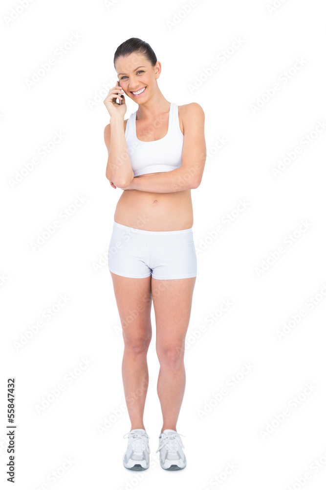 Happy woman in sportswear on the phone Happy woman in sportswear on the phone
