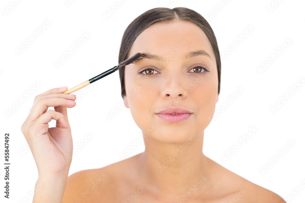 Woman brushing her eyebrow