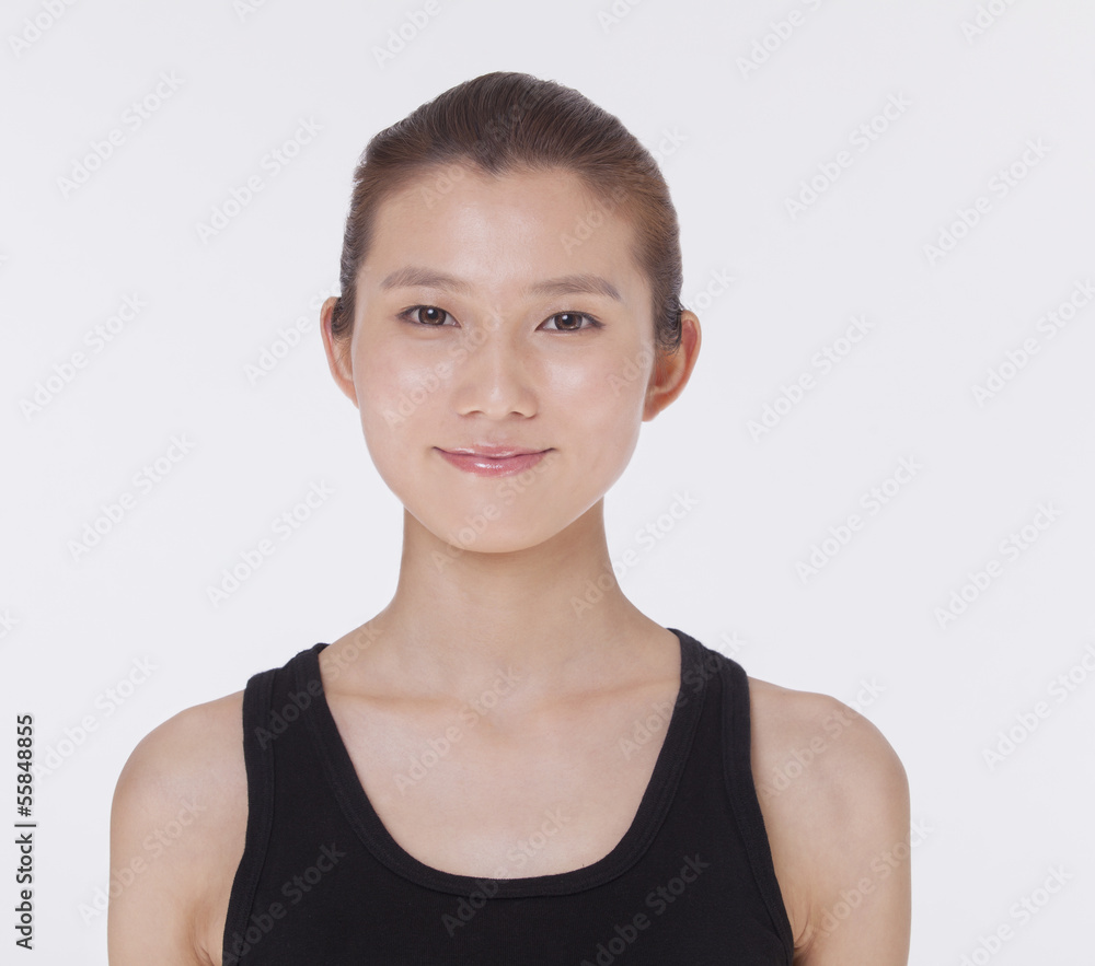 Portrait of smiling beautiful young woman in a black tank top, studio shot Portrait of smiling beautiful young woman in a black tank top, studio shot
