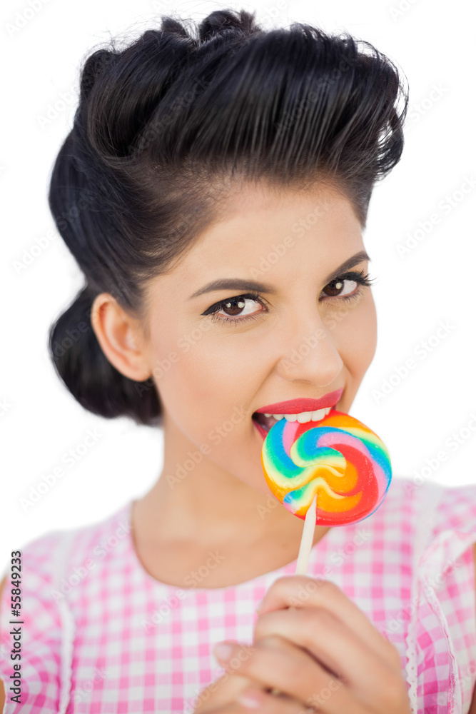 Attractive black hair model chewing a colored lollipop