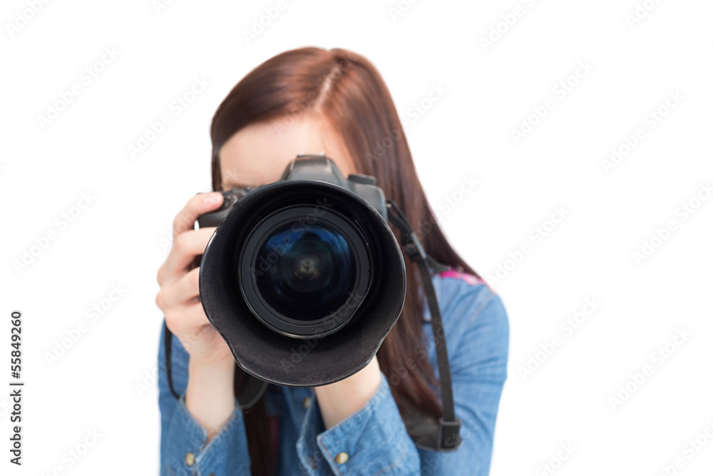 Cute young photographer taking picture of camera