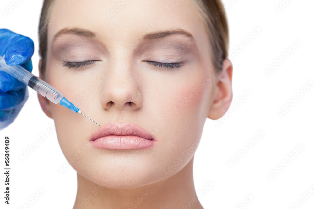 Relaxed beautiful model receives cosmetic injection above lips Relaxed beautiful model receives cosmetic injection above lips