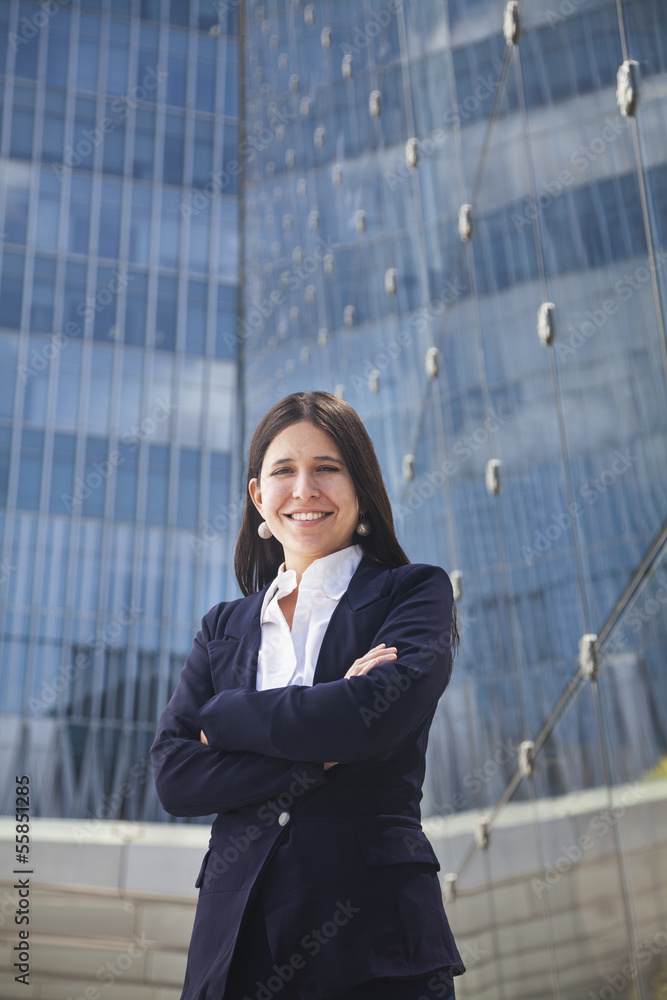 Portrait of smiling young businesswoman with arms crossed outdoors in Beijing, China Portrait of smiling young businesswoman with arms crossed outdoors in Beijing, China