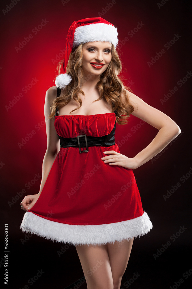Sexy Santa. Beautiful young woman in Santa costume smiling while Sexy Santa. Beautiful young woman in Santa costume smiling while
