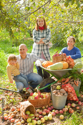family with harvest in garden