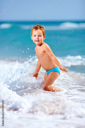 cute kid boy having fun in sea surf, crimea © Olesia Bilkei