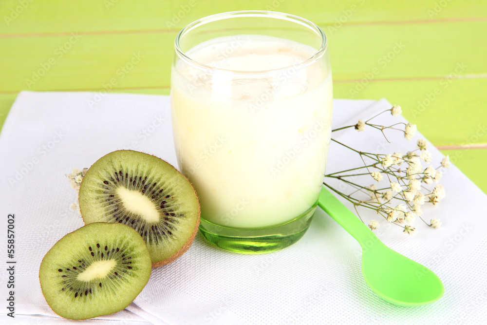 Delicious yogurt with kiwi in glass on wooden table close-up Delicious yogurt with kiwi in glass on wooden table close-up