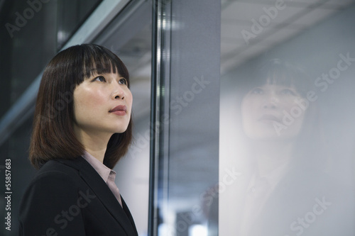 Businesswoman looking through glass, reflection, Beijing Free Download Businesswoman looking through glass, reflection, Beijing - GFXLoad