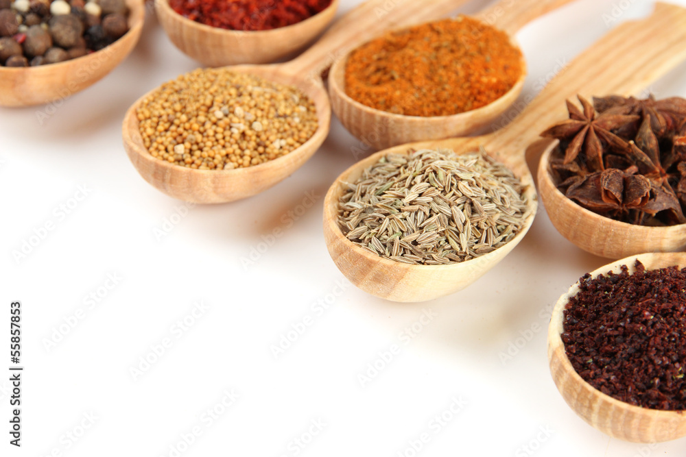 Assortment of spices in wooden spoons, isolated on white Assortment of spices in wooden spoons, isolated on white