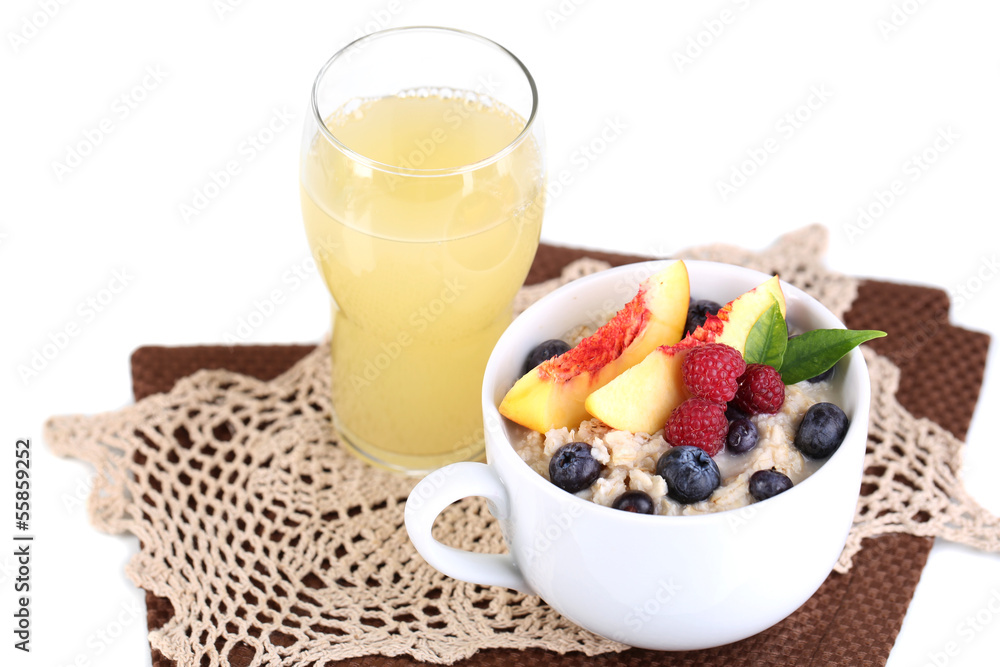 Oatmeal in cup with berries on napkins isolated on white Oatmeal in cup with berries on napkins isolated on white
