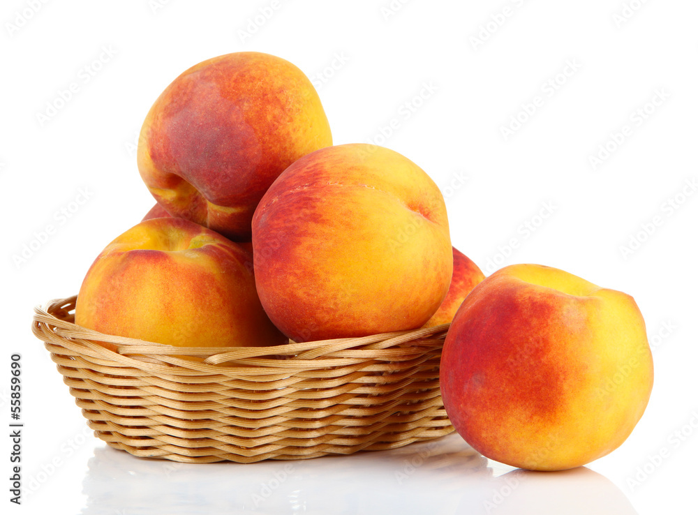 Ripe sweet peaches in wicker basket, isolated on white Ripe sweet peaches in wicker basket, isolated on white