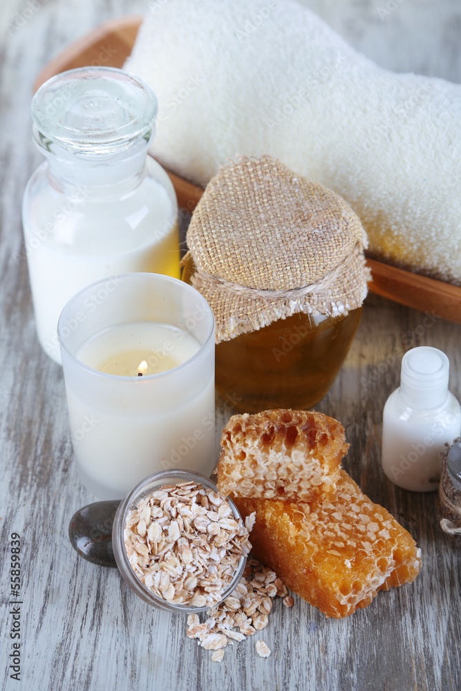 Honey and milk spa with oils and honey on wooden table close-up Honey and milk spa with oils and honey on wooden table close-up
