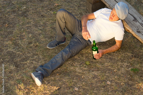 High angle view of an alcoholic man lying down