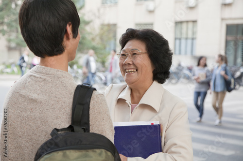 Student talking with his professor  photo