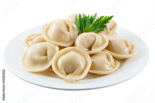 Dumplings and parsley - russian pelmeni - italian ravioli - on w photo