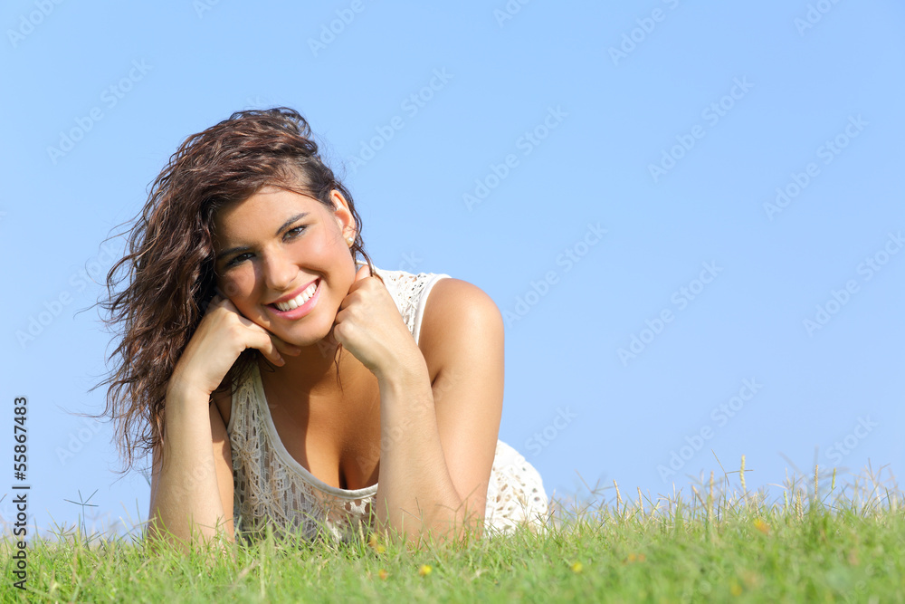 Portrait of an attractive woman lying on the grass Portrait of an attractive woman lying on the grass
