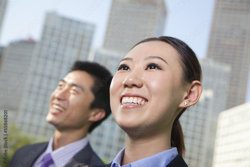 Portrait of two young business people outside in the business district, Beijing Portrait of two young business people outside in the business district, Beijing
