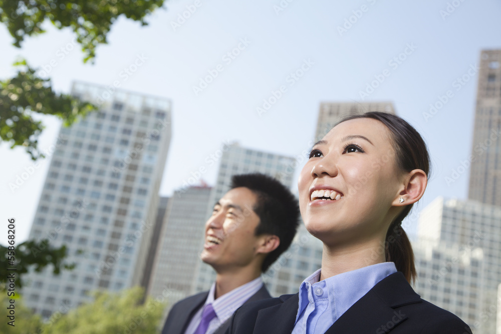 Portrait of two young business people outside in the business district, Beijing Portrait of two young business people outside in the business district, Beijing