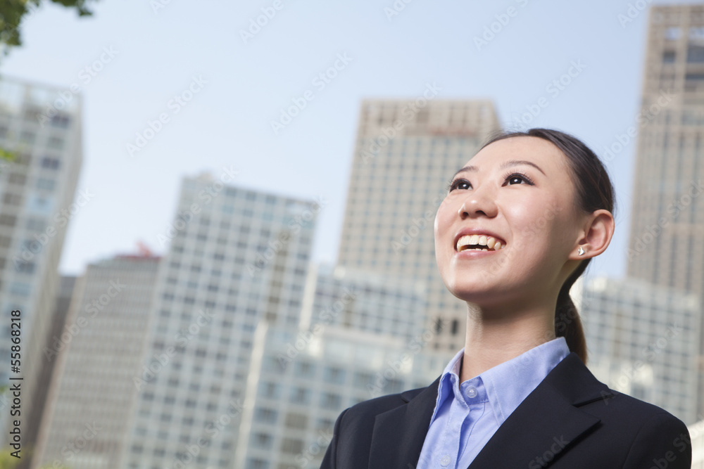 Young businesswoman outside among skyscrapers, Beijing Young businesswoman outside among skyscrapers, Beijing