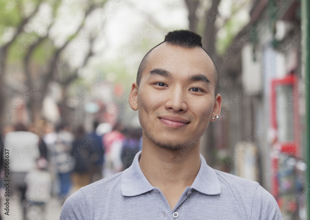 Fototapeta premium Young Man with Mohawk haircut smiling looking at camera