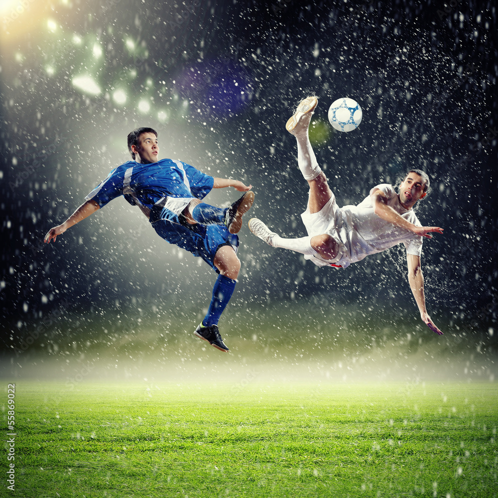 two football players striking the ball - obrazy, fototapety, plakaty 