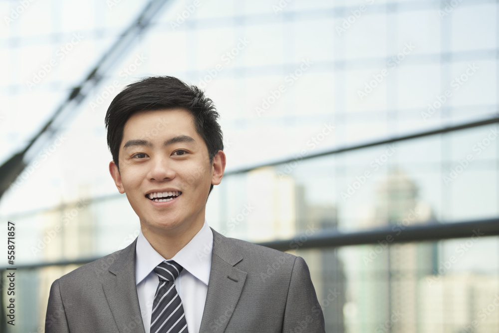 Portrait of young businessman with cityscape in background, Beijing, China Portrait of young businessman with cityscape in background, Beijing, China