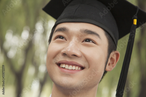 Portrait Of A Young Univercity Graduate Looking Up photo