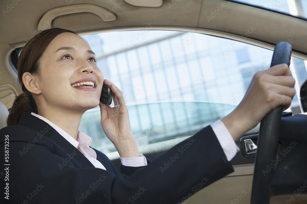 Businesswoman Driving and On the Phone in Beijing Businesswoman Driving and On the Phone in Beijing