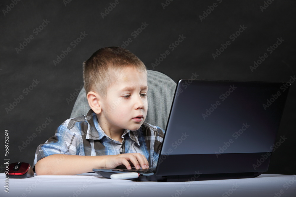 Computer addiction child with laptop notebook Computer addiction child with laptop notebook