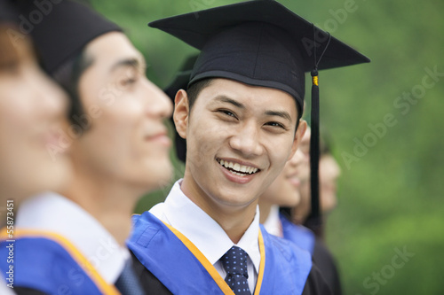 Young Man Smiling in a Row of Young University Graduates photo