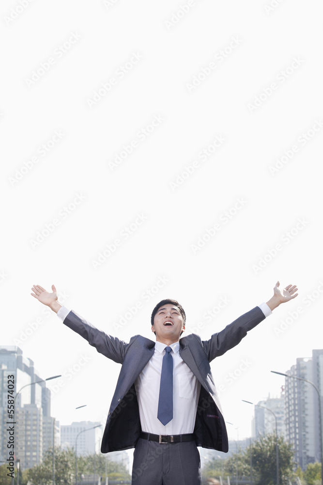 Young Businessman with Arms Raised Young Businessman with Arms Raised