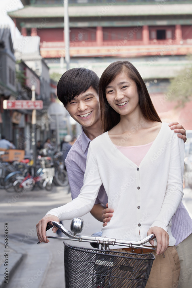 Fototapeta premium Young Heterosexual Couple on a Bicycle in Beijing