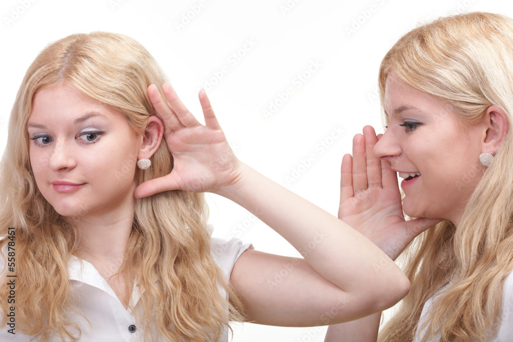society gossip - two happy young girlfriends talking white backg society gossip - two happy young girlfriends talking white backg