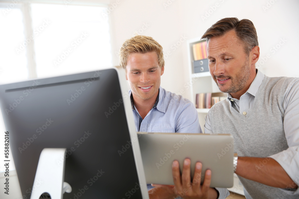 Manager with employee working in office Manager with employee working in office