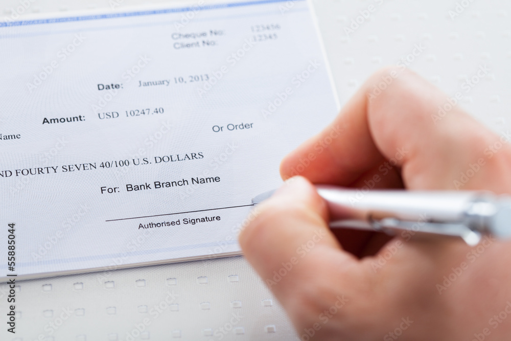 Hand With Pen Over Checkbook Hand With Pen Over Checkbook