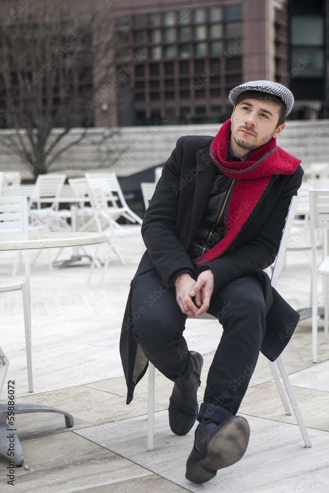 sad man wearing check cap and red scarf scarf Stock Adobe Stock