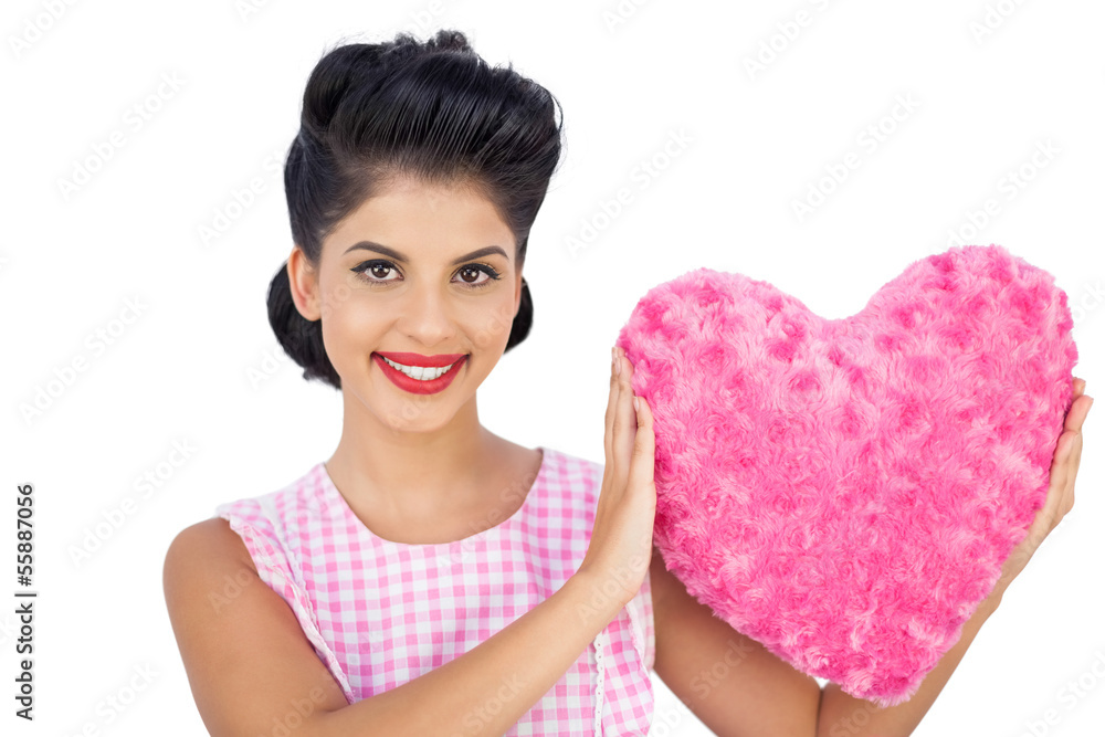 Lovely black hair model holding a pink heart shaped pillow Lovely black hair model holding a pink heart shaped pillow