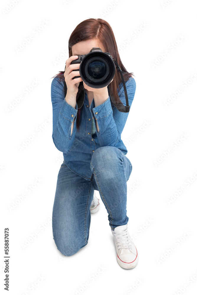 Pretty young photographer taking picture of camera Pretty young photographer taking picture of camera