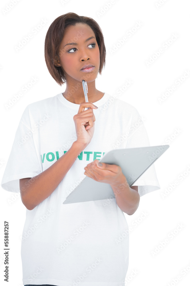 Thoughtful volunteer woman holding clip board Thoughtful volunteer woman holding clip board