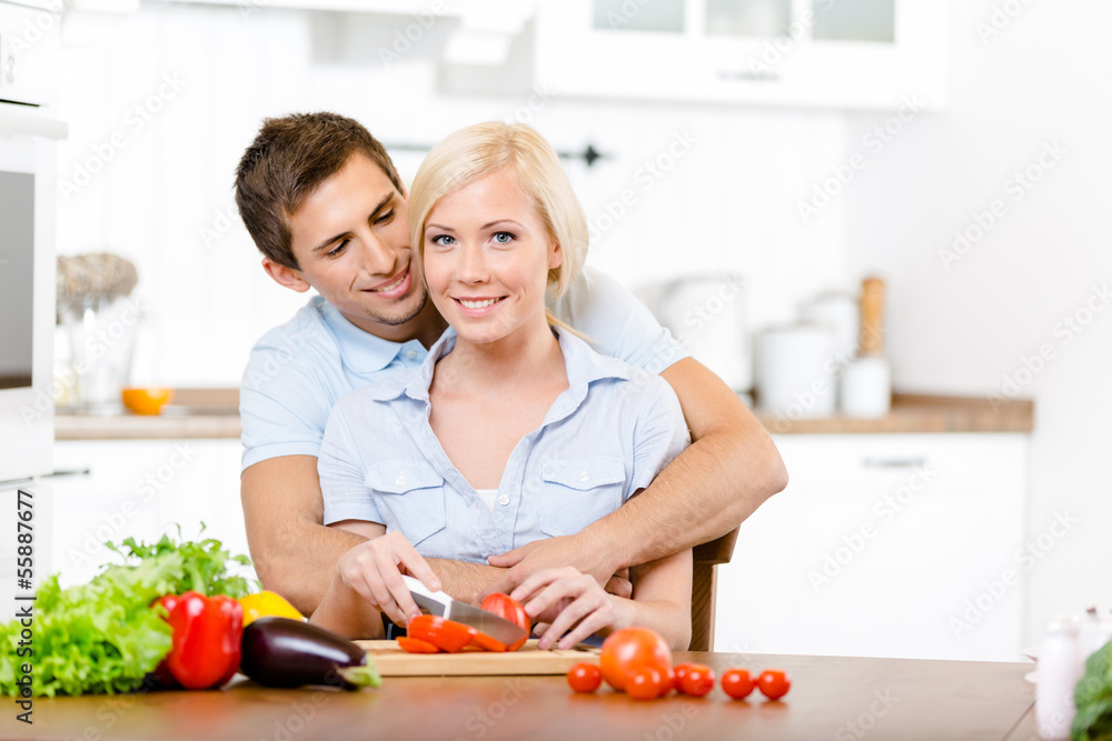 Young couple preparing breakfast sitting together