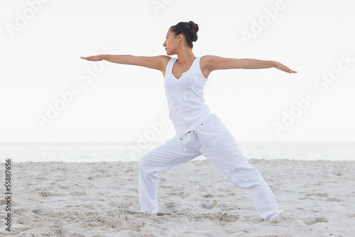 Brunette woman stretching in yoga pose
