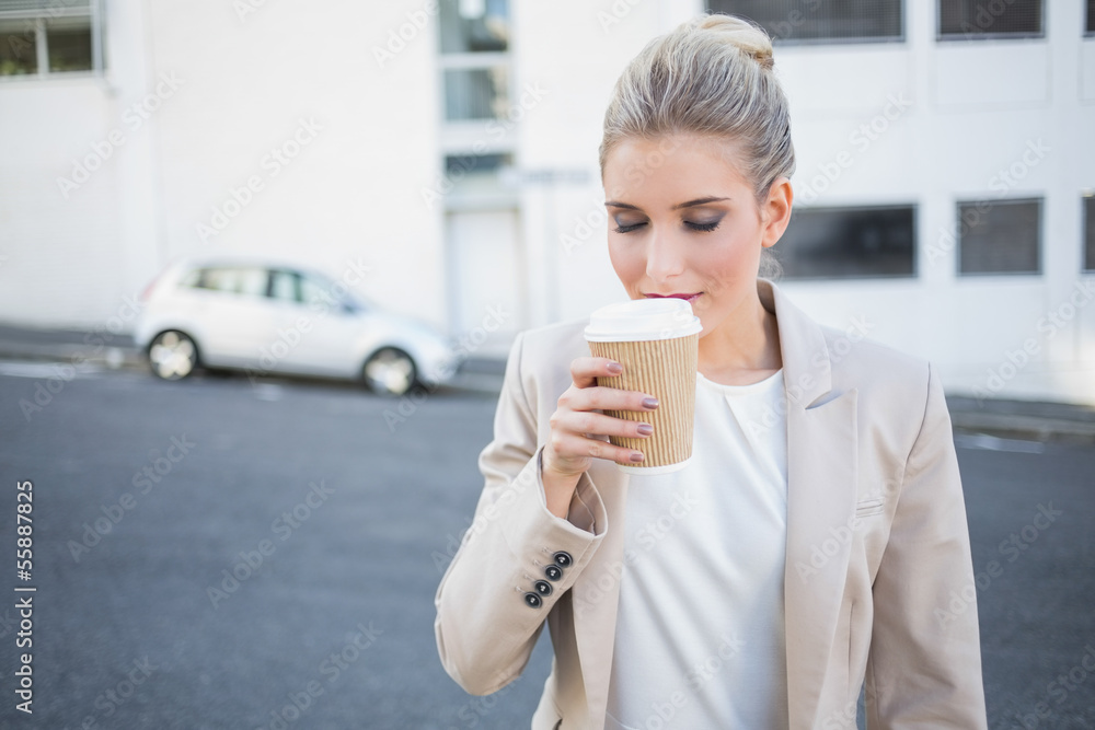 Peaceful stylish businesswoman smelling coffee Peaceful stylish businesswoman smelling coffee