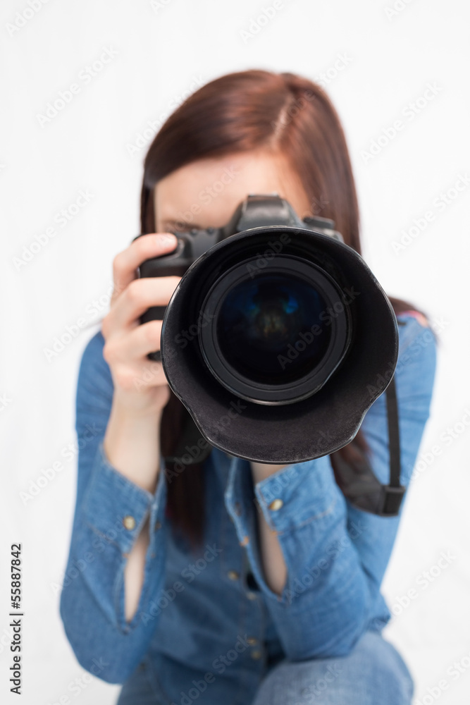 Casual young photographer taking picture of camera Casual young photographer taking picture of camera