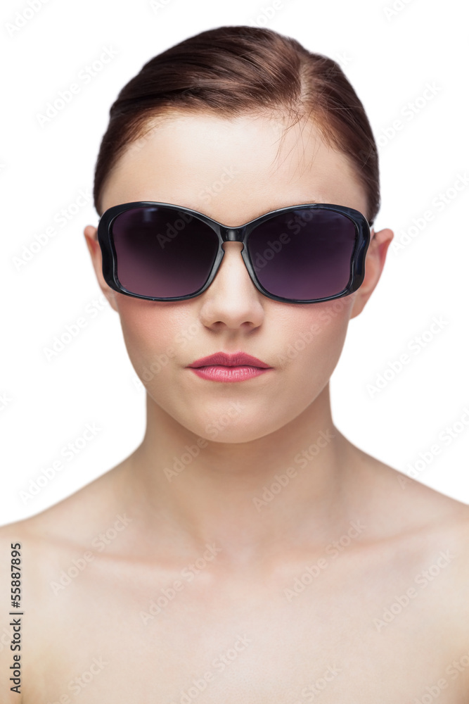 Serious young model wearing classy sunglasses Serious young model wearing classy sunglasses