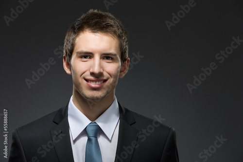 Front view of smiley business man in dark suit  © Karramba Production